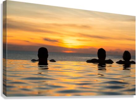 Silhouetted heads against infinity edge pool  Canvas Print