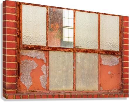 Old rusty window in warehouse painted red and orange  Canvas Print