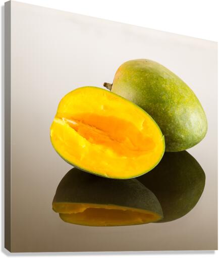Two mangoes on reflecting surface  Canvas Print