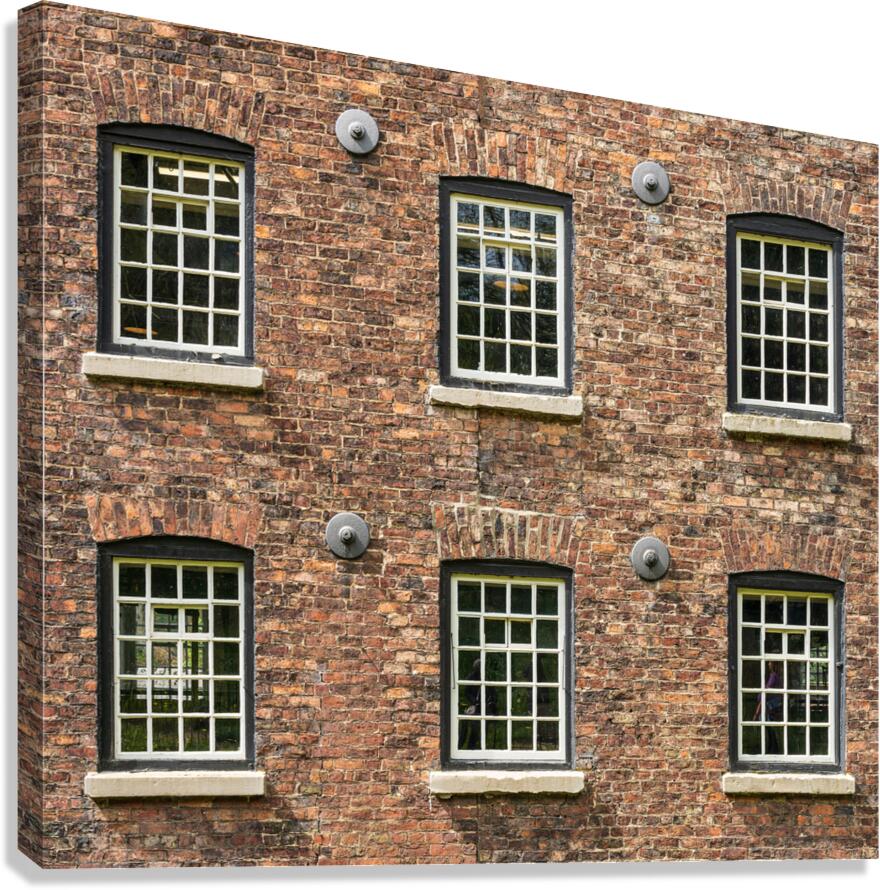 Restored industrial cotton mill with pattern of windows  Canvas Print