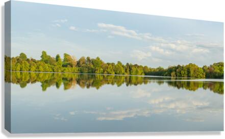 View across the Mere to a clear reflection of distant trees in E  Canvas Print