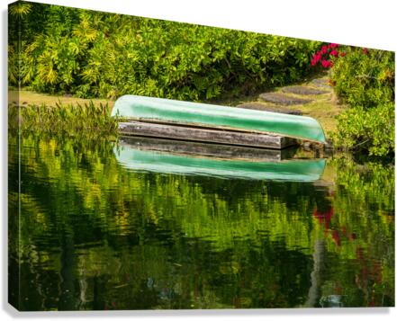 Green canoe on dock reflecting into calm lake or pond in garden  Impression sur toile