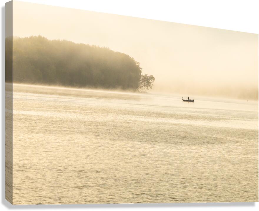 Fisherman fishing in Mississippi river on misty autumn morning  Canvas Print