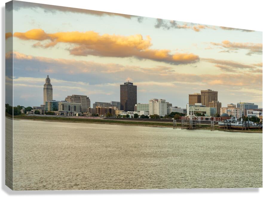 Skyline of Baton Rouge at sunset over river barges Canvas Print