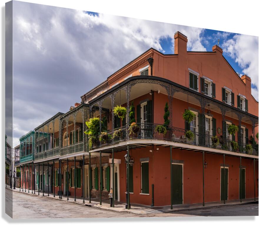 Traditional wrought iron balcony on ochre New Orleans house  Canvas Print