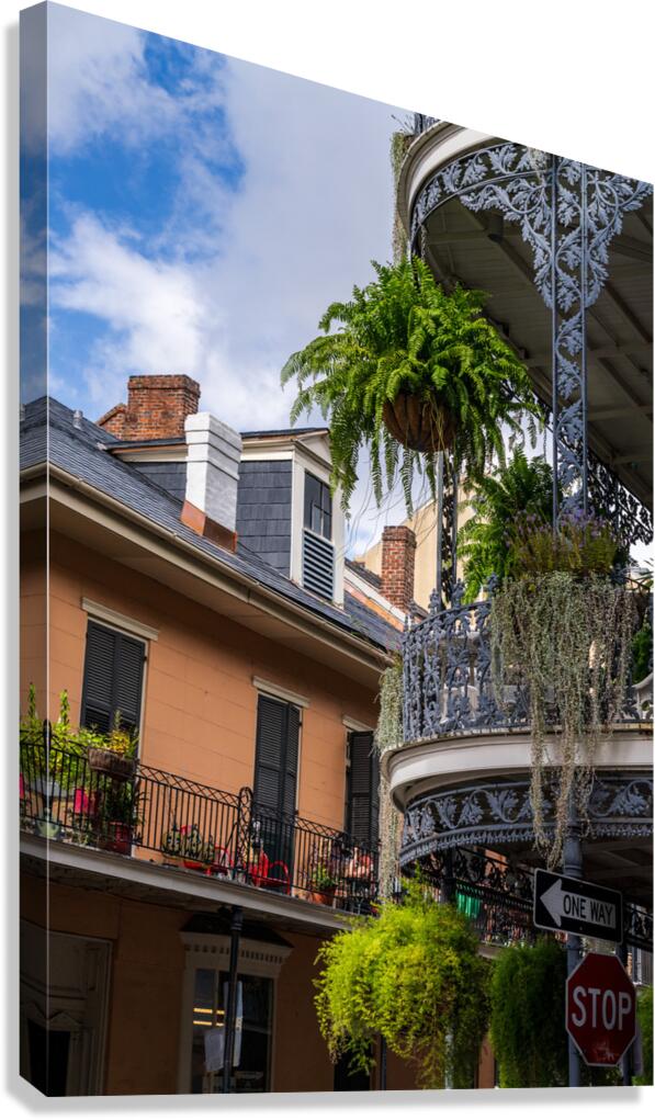Traditional wrought iron balcony on brick New Orleans house  Canvas Print