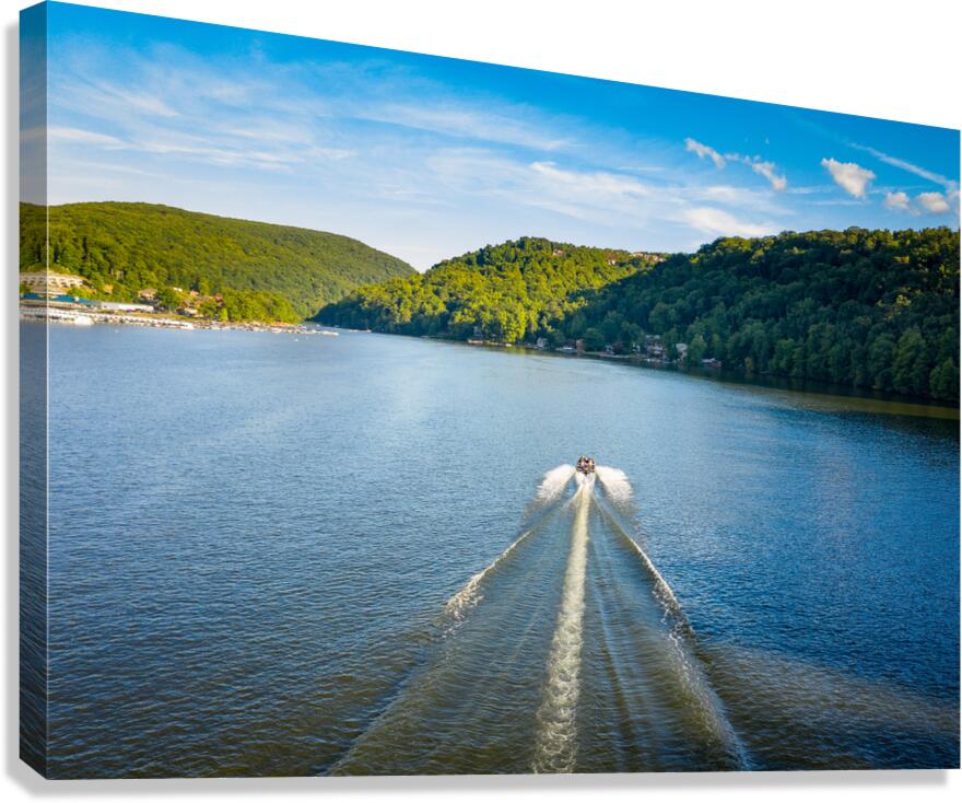 Speedboat on Cheat Lake on a summer evening with boats docked in Canvas Print