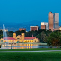 Skyline of Denver at dawn from City Park with boathouse