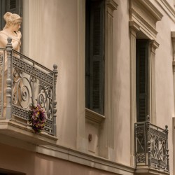 Statue on balcony in Plaka in Athens