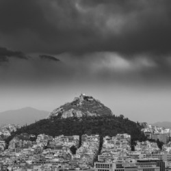 Lycabettus hill rises above Athens in a storm