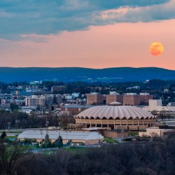 Super pink moon rises above the WVU coliseum on Evansdale campus