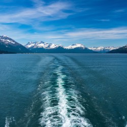 Cruise boat wake leaving town of Valdez in Alaska