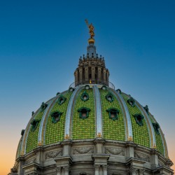 Sun sets behind the ornate dome of Pennyslvania State Capitol