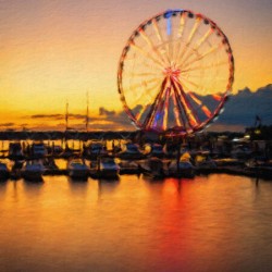 Impressionistic view of Ferris wheel at National Harbor at sunse