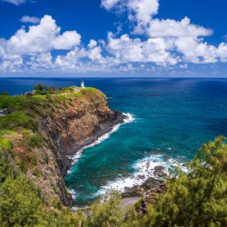 Kilauea lighthouse on headland against blue sky on Kauai