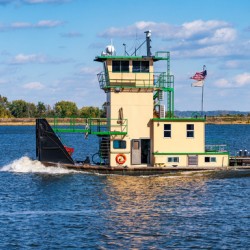 Tug boat or pusher boat leaving Lock and Dam 22 on Mississippi r