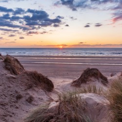 Sunset over Formby Beach through dunes