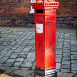 Victoria era red post office mailbox in street