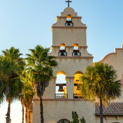 Spanish mission style church tower at sunset