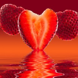 Fresh sliced strawberry in heart shape reflected