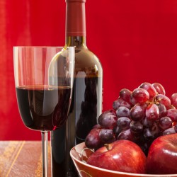 Red wine bottle and fruit with glass