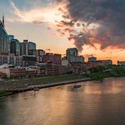 Skyline of Nashville in Tennessee during dramatic sunset over the river