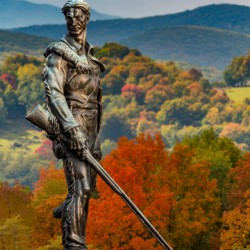 Mountaineer statue from WVU with fall leaves in West Virginia
