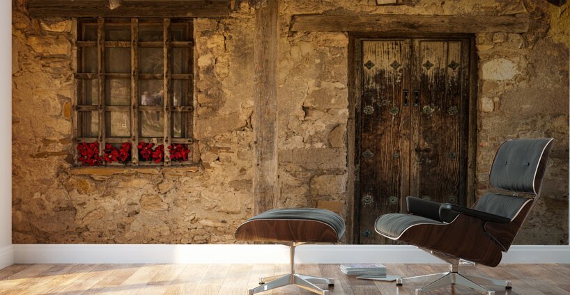Rustic San Juan building with a barred window red flowers and a Wall Murals