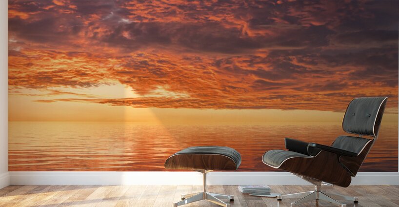 Dramatic sunset reflected in the smooth ripples of a lake or oce Wall Murals