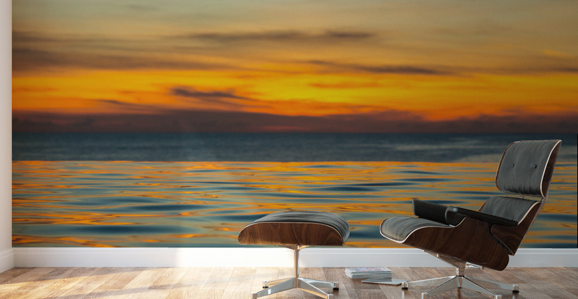 Infinity edge pool with sea underneath sunset Wall Murals
