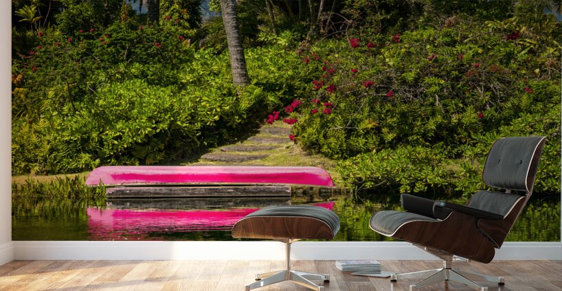 Red canoe on dock reflecting into calm lake or pond in garden Wall Murals
