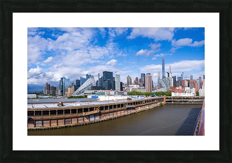 Tall office and apartment buidlings along the waterfront in Manh Picture Frame print