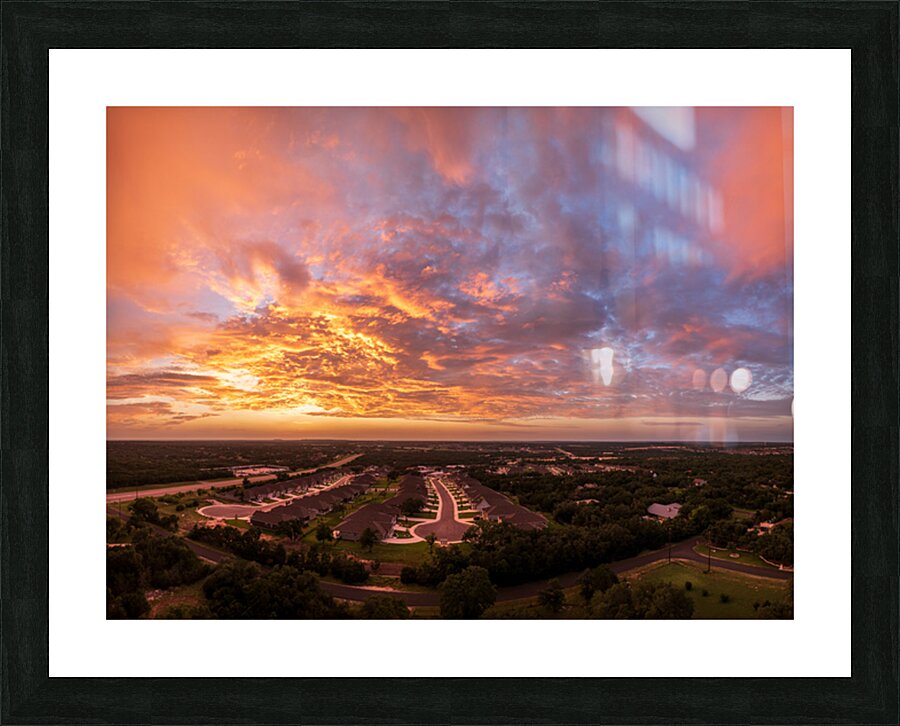 Dramatic sunset seen from drone over Georgetown Texas residentia Picture Frame print