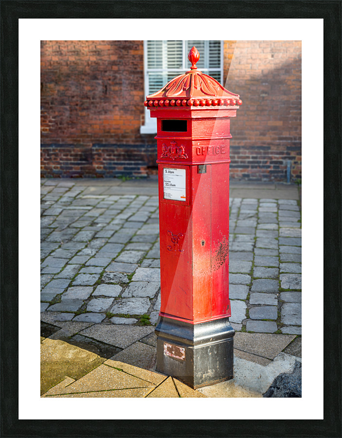 Victoria era red post office mailbox in street  Framed Print Print