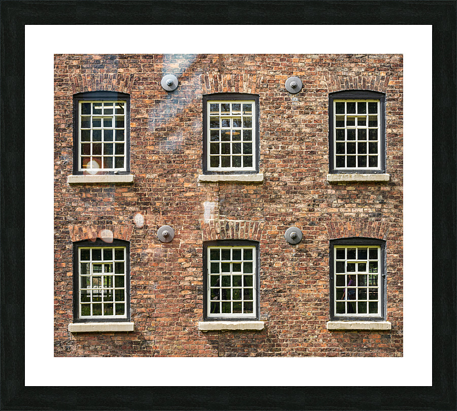 Restored industrial cotton mill with pattern of windows  Framed Print Print