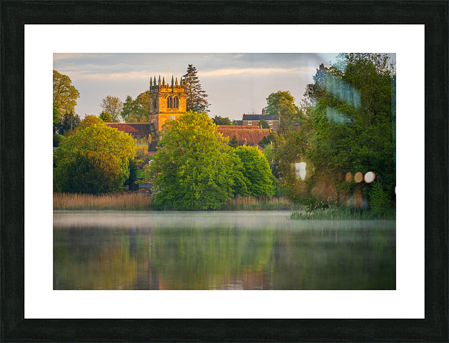 Sunset view across Ellesmere Mere in Shropshire to church  Framed Print Print