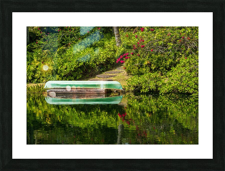 Green canoe on dock reflecting into calm lake or pond in garden  Framed Print Print