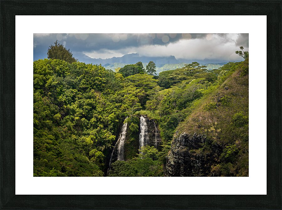 Opaekaa Falls sunlit as dark storm clouds gather over the hills  Framed Print Print