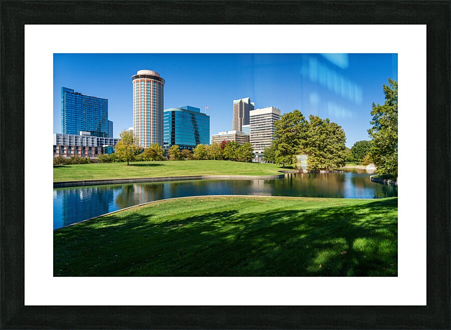 Offices and cityscape of St Louis Missouri seen from lake  Framed Print Print