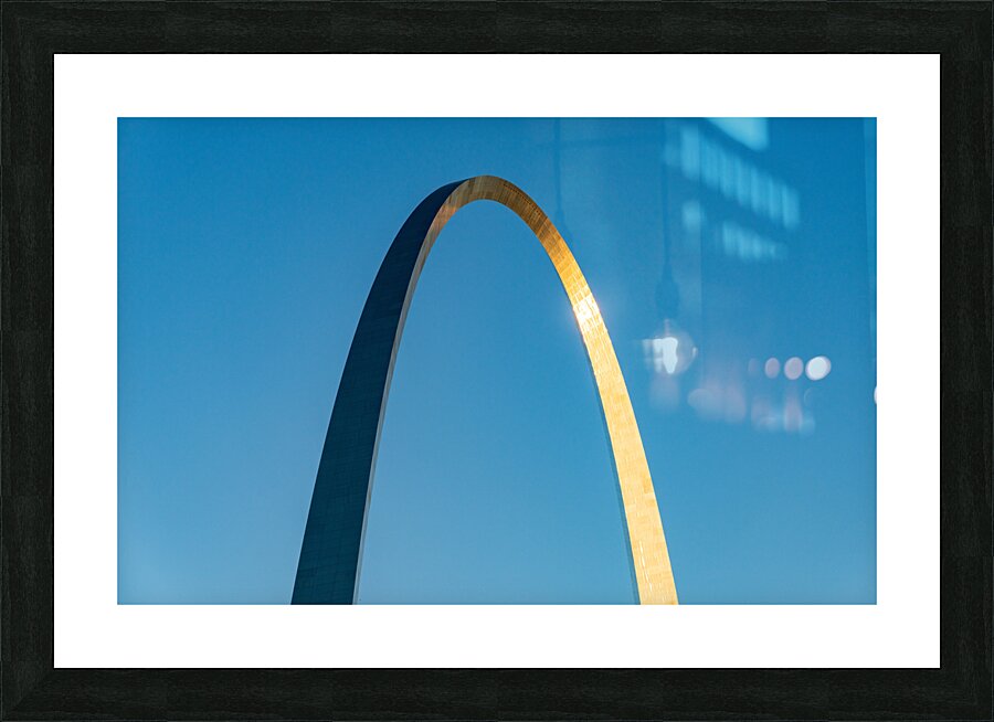 Unusual view of Gateway Arch at sunrise against blue sky  Framed Print Print