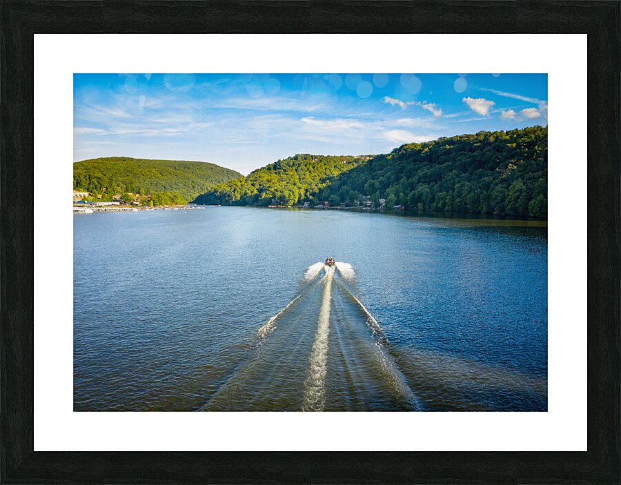 Speedboat on Cheat Lake on a summer evening with boats docked in Picture Frame print