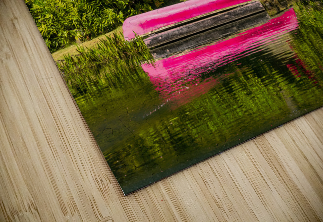 Red canoe on dock reflecting into calm lake or pond in garden Steve Heap Puzzle