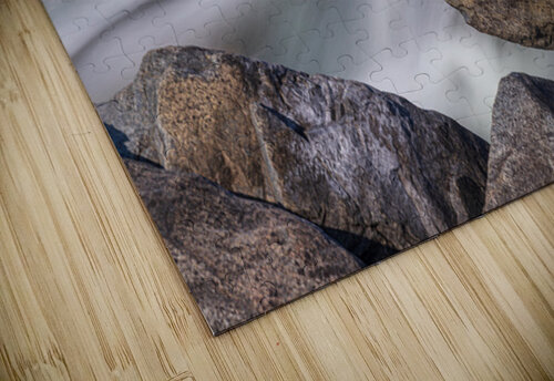 Pebbles balanced on rocks in raging river illustrating resilienc Steve Heap puzzle