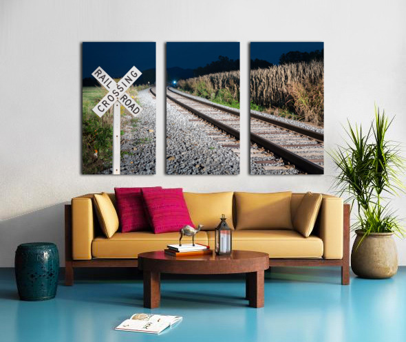 Oncoming train with railroad crossing sign Split Canvas print