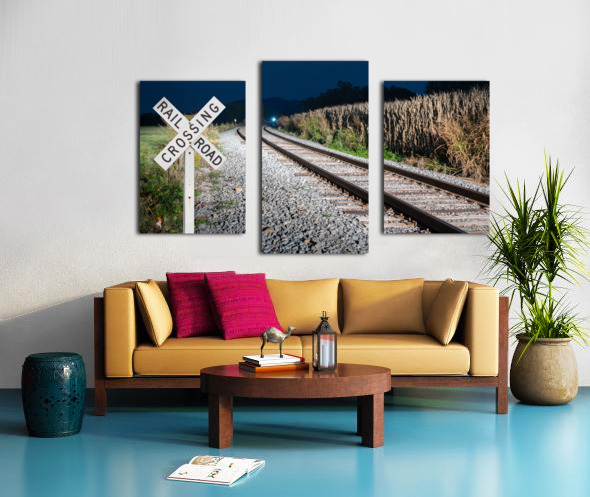 Oncoming train with railroad crossing sign Canvas print