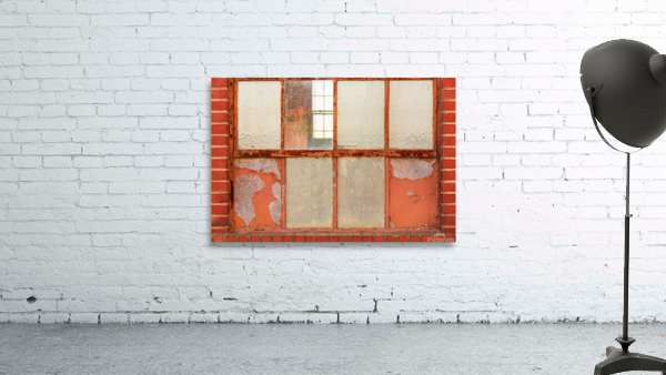 Old rusty window in warehouse painted red and orange by Steve Heap