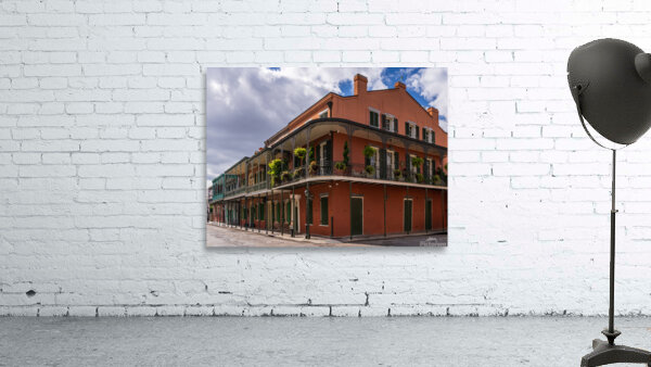 Traditional wrought iron balcony on ochre New Orleans house Wall Preview