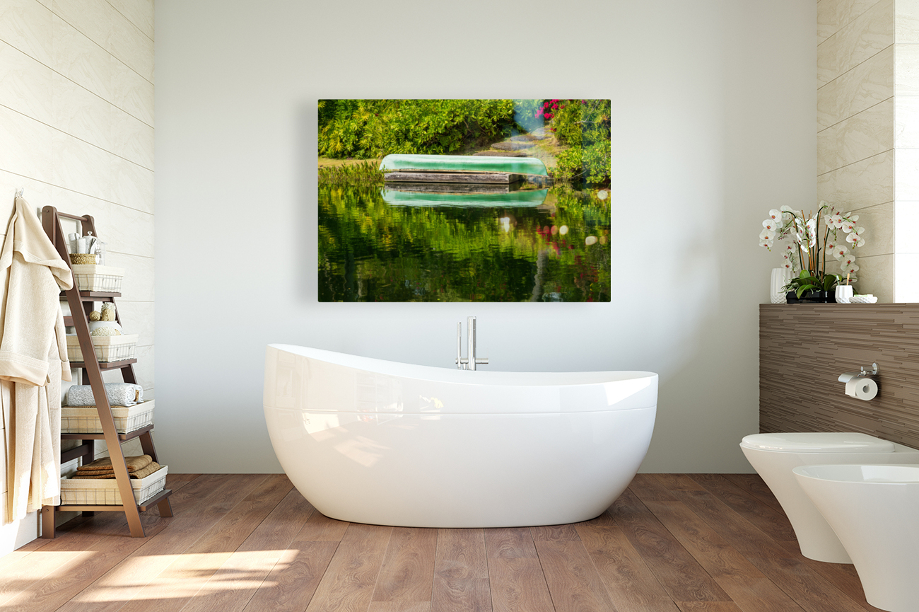Green canoe on dock reflecting into calm lake or pond in garden Reproduction
