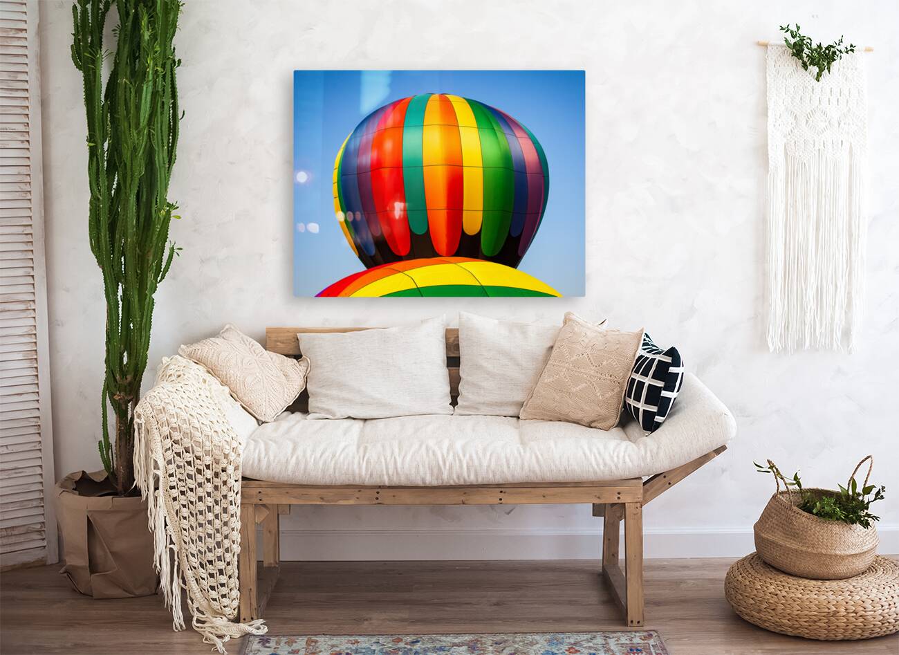 Colorful hot air balloon rising above another with blue sky Reproduction