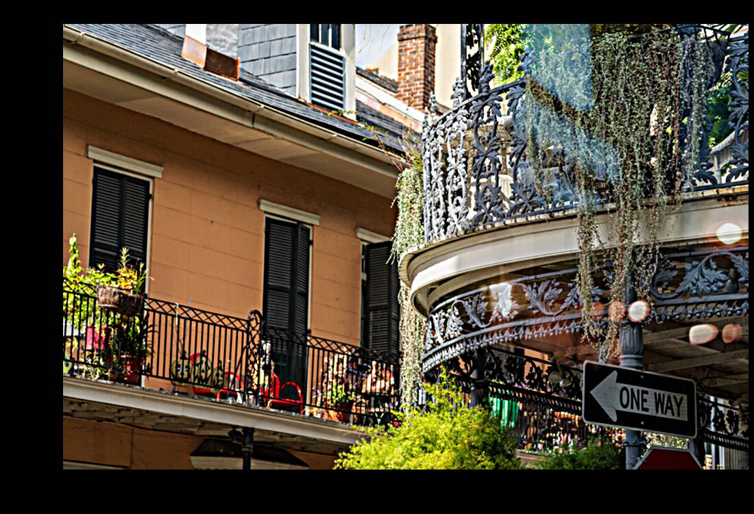 Traditional wrought iron balcony on brick New Orleans house Reproduction